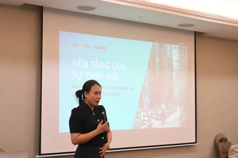 Trainer presenting in front of a projector screen at the Foundation of Change workshop